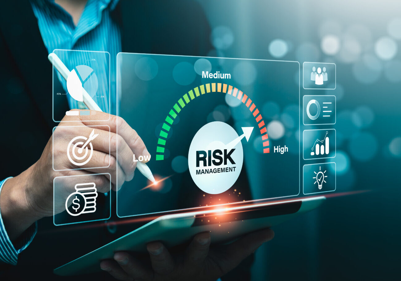 Risk management is the process of identifying, assessing, and mitigating risks to minimize future occurrences, ensuring organizational readiness and stability amidst unforeseen challenges. Man analyzing risk management on digital screen.